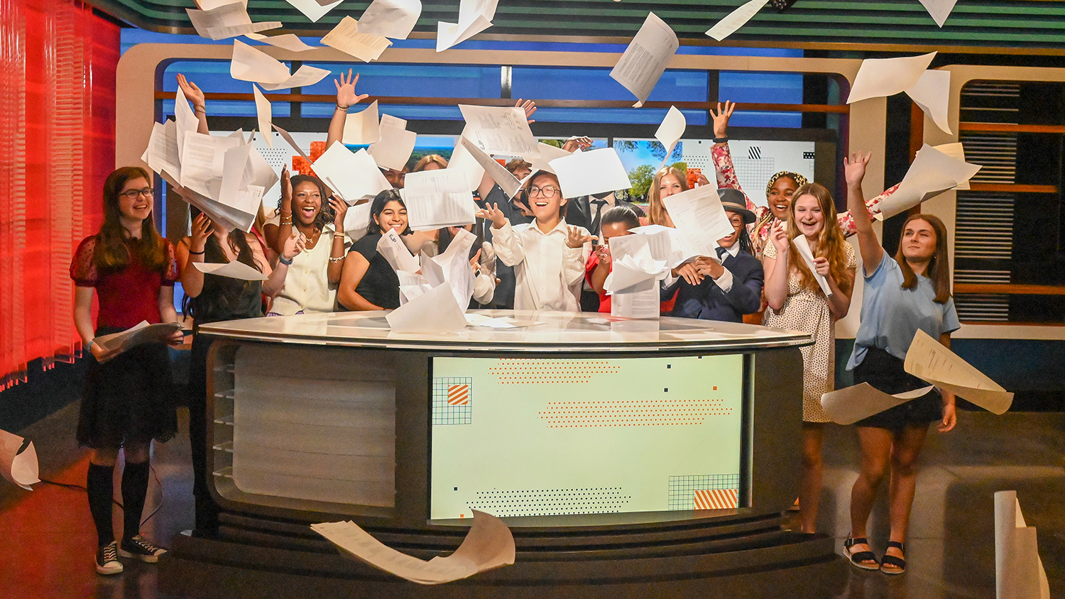 The EJP students throw their scripts in the air.