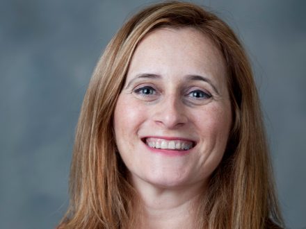 Headshot of Mayte de Lama on gray background