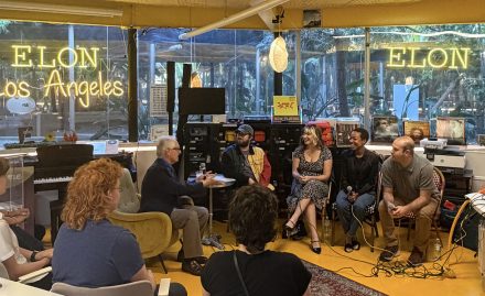 Participants gather for a discussion at Elon University Los Angeles, seated in a studio-style space with large windows and an audience in attendance.