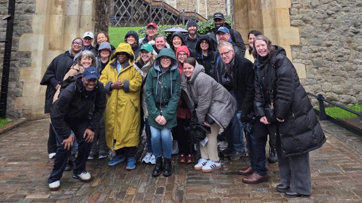 2026 London Experience members brave cold and damp weather for a group photo.