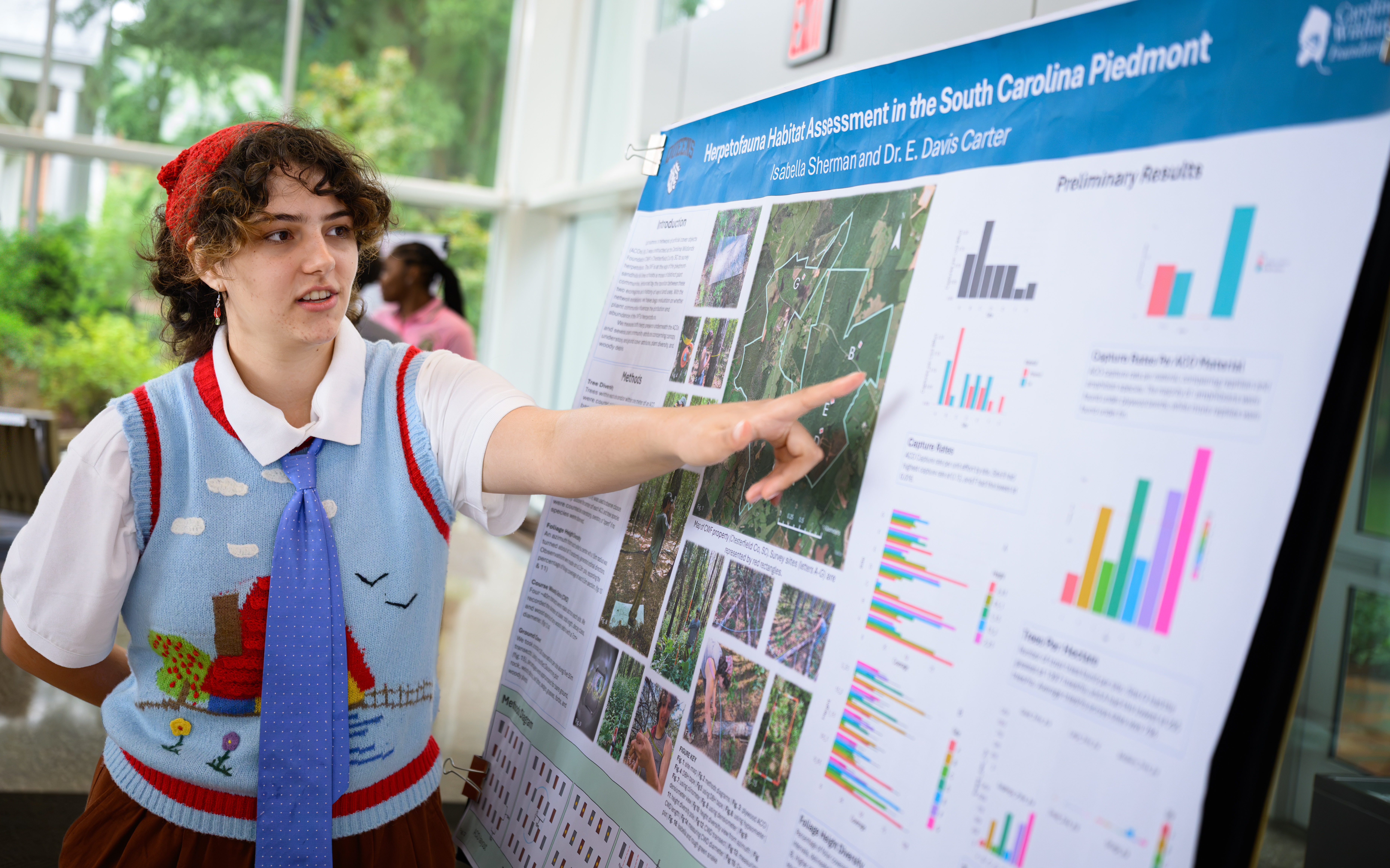 Isabella Sherman points to data collected during her study of herpetofauna habitats in the South Carolina Piedmont during the Summer Undergraduate Research Experience.