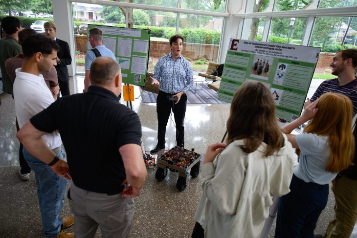 An �þ��� student demonstrates a computer vision-based robot designed to assist with intercropping farming during the Summer Undergraduate Research Experience presentations.