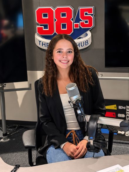 Rylee Marchand sits in radio station chair