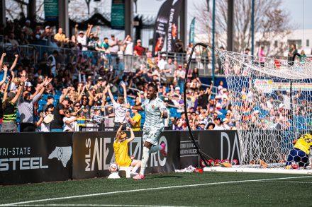 Soccer player on the field in front of fans in the stadium