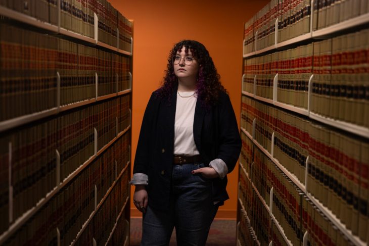 a portrait of a person standing in the ELon Law Libraryy