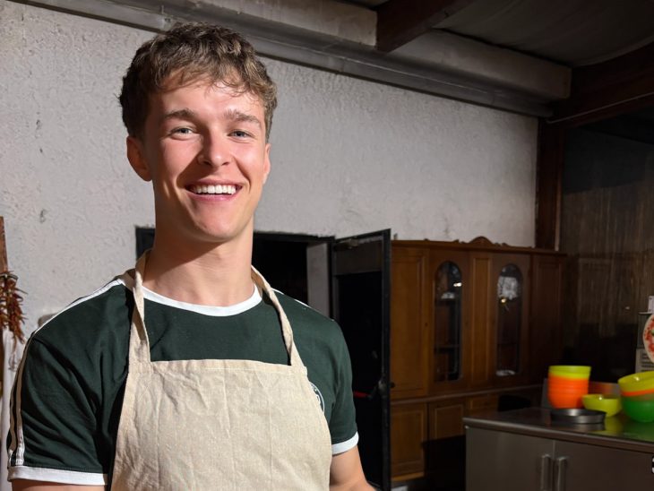 A smiling person wearing an apron labeled “Antico Frantoio Sorrento"