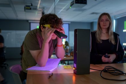 Student looking at light sources in the "Exploring astronomical and poetic light" Phoenix Summer course.