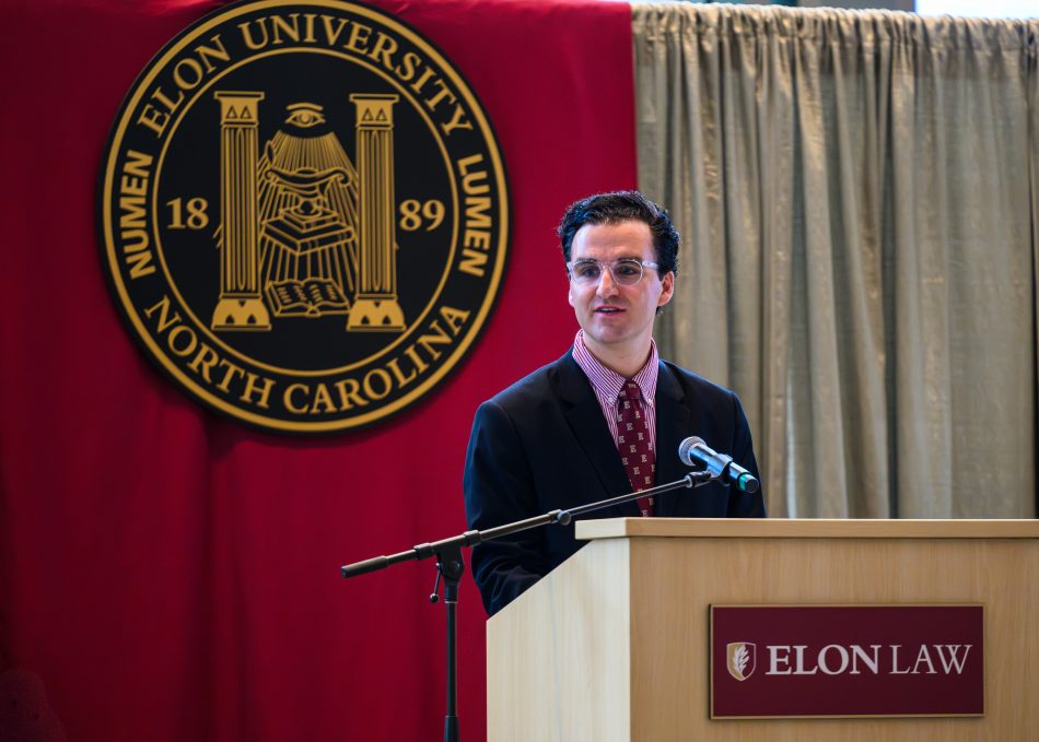A person at a podium on stage speaking.