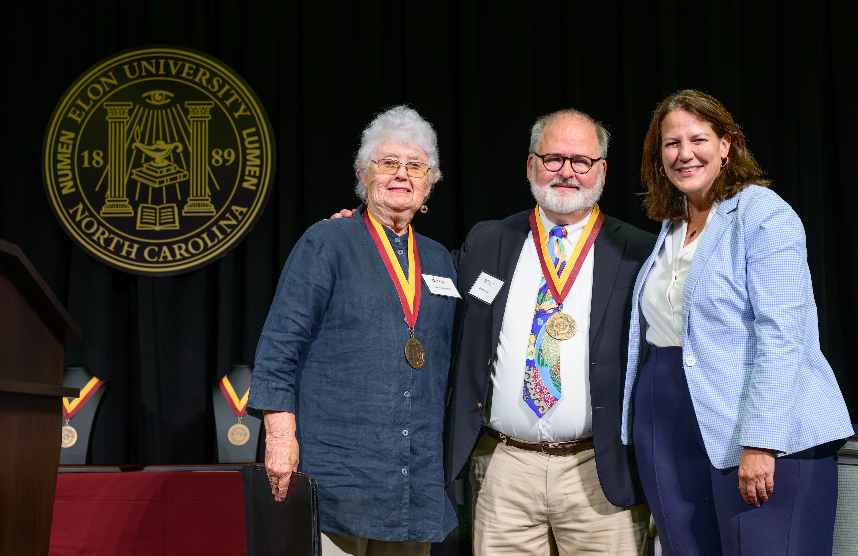  Jim Donathan wears the Elon Medallion while posing with Lela Faye Rich and Elon President Connie Ledoux Book during Opening Day.