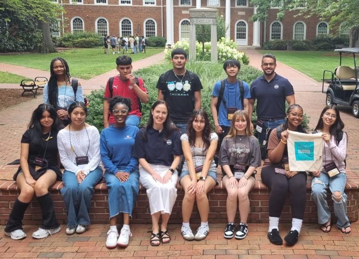 Group photo of Elon Academy scholars and teaching team outdoors on Elon's campus.