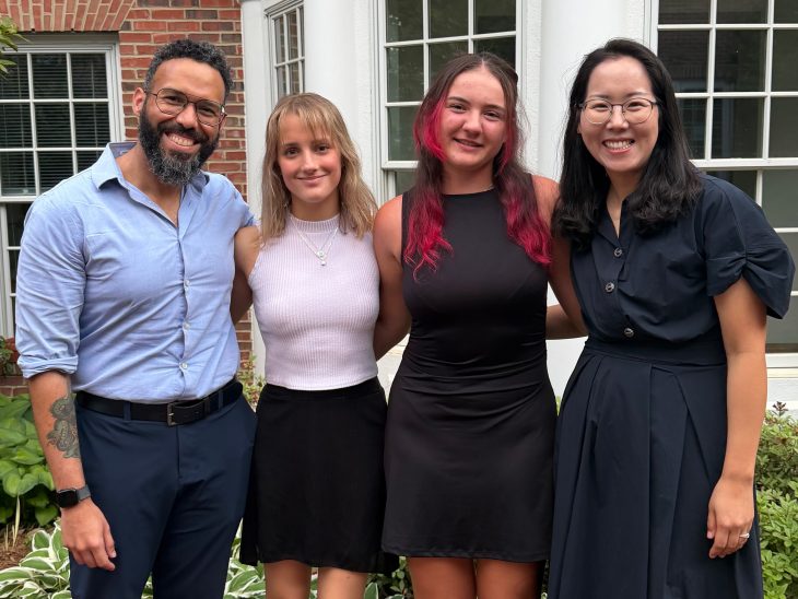 Two professors standing with two students they mentor who are researching cardiac complications.