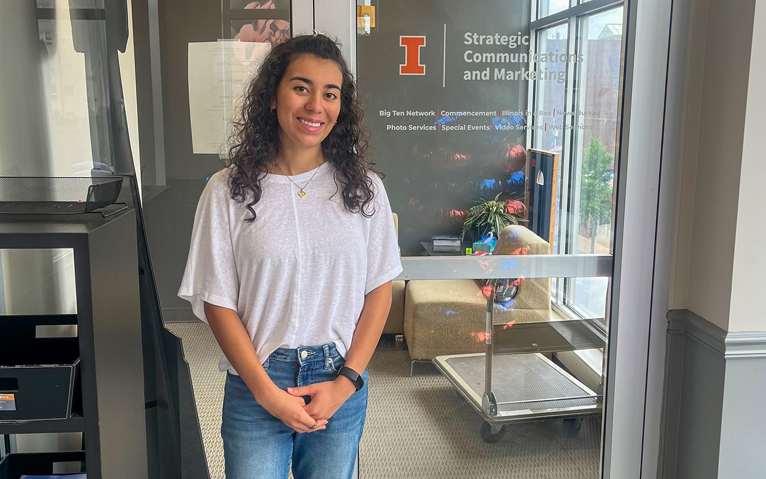 Miranda Burgos stands outside her office at the University of Illinois Urbana-Champaign.