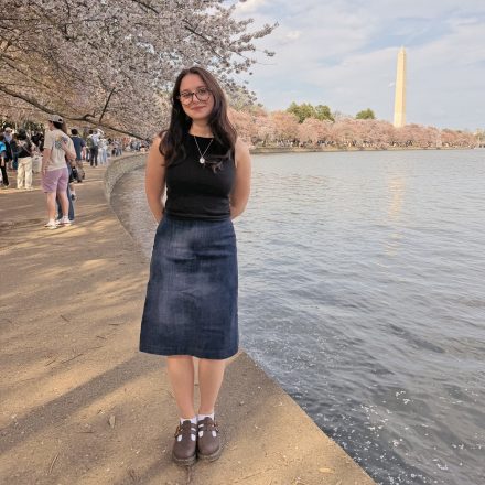 Sophie Rosenthal stands outdoors in Washington, D.C., with the Washington Monument visible in the background.
