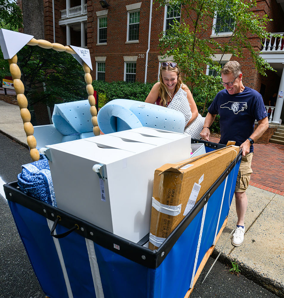 Queens Chaplain Adrian Bird helps daughter Lydia move onto campus.