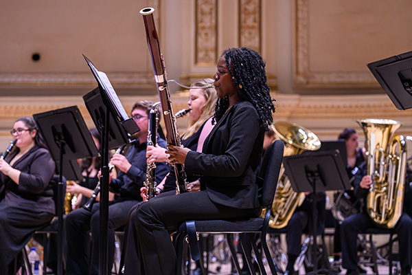 A bassoonist performs with the Elon University Wind Ensemble onstage at Carnegie Hall.