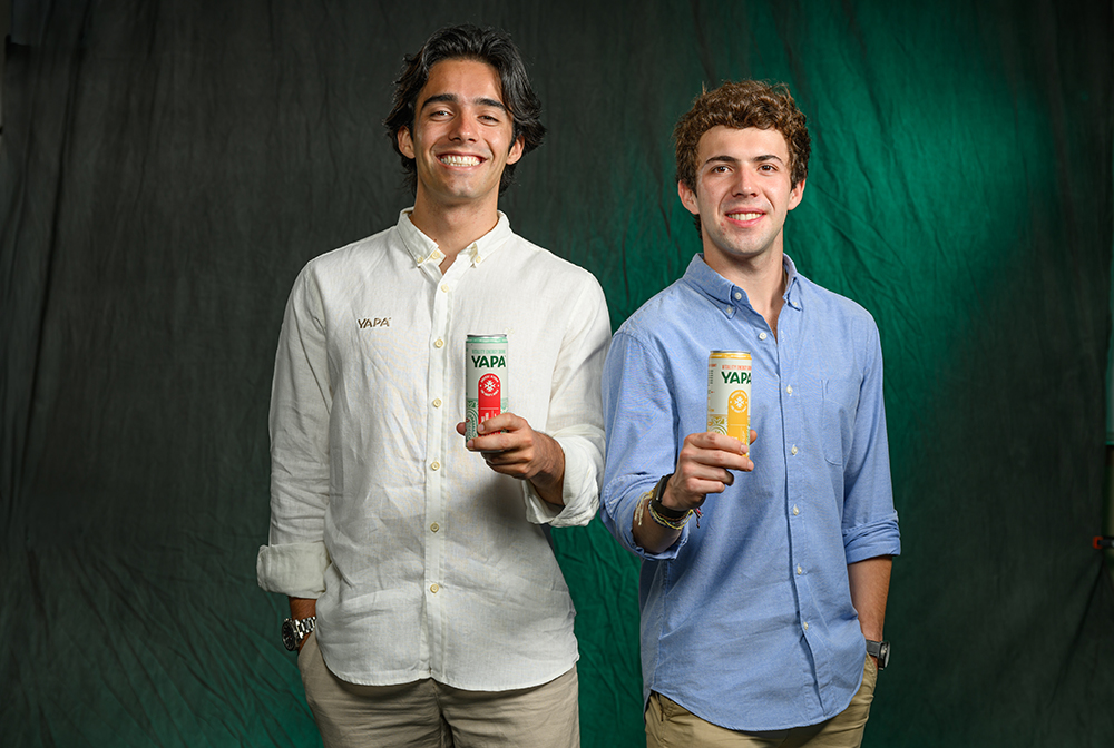 Bernardo Vargas-Lopez and Juan Daniel Chiriboga pose while holding cans of their YAPA energy drinks.