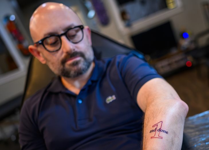 Zak Kramer's left arm with the one and done tattoo in the foreground.