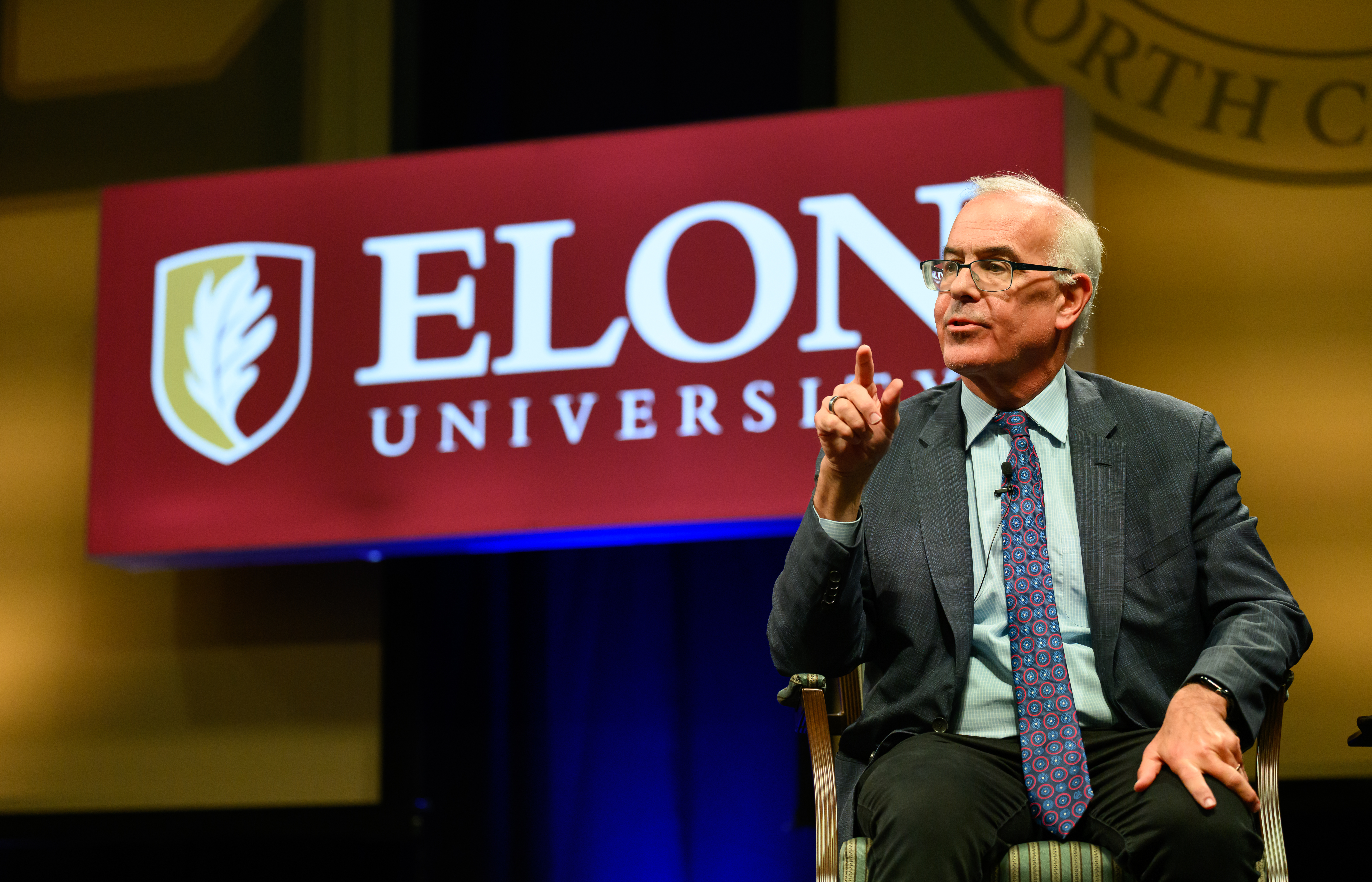 David Brooks gestures while seated onstage during a question-and-answer session following his Fall Convocation address.