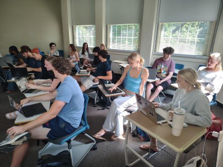 Students sitting at desks in a classroom during a German Studies class.