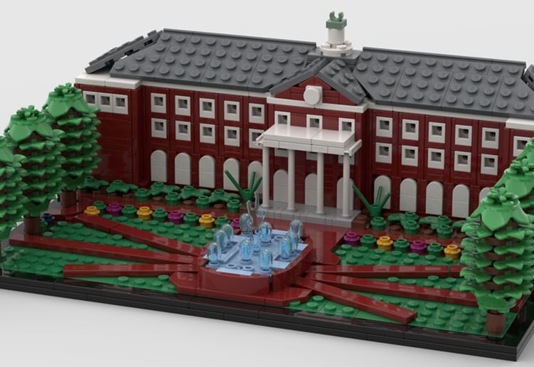 LEGO model of a red-brick academic building with white columns, landscaped grounds, trees and a fountain in front.