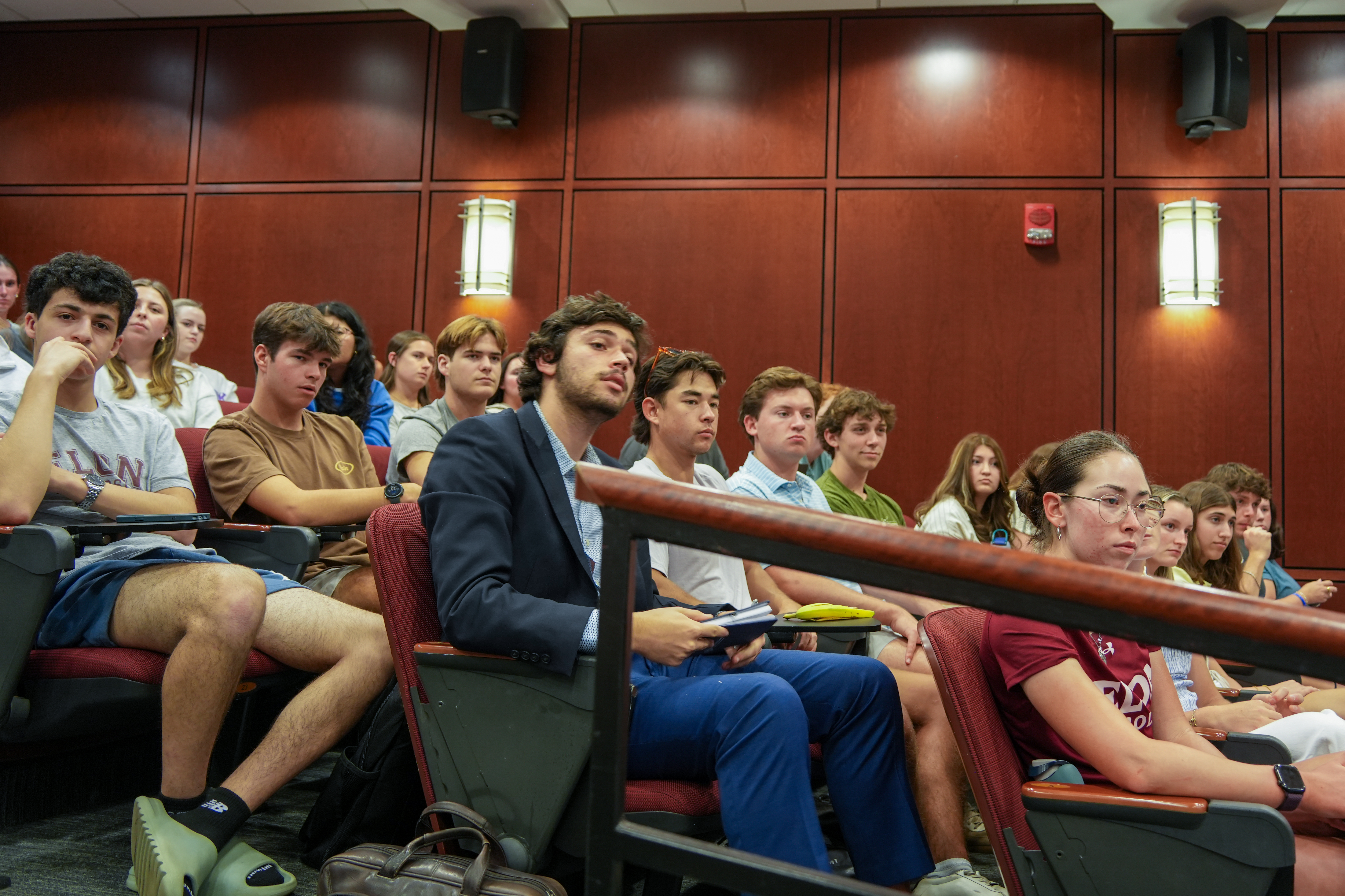 Students seated in LaRose Digital Theatre watch the Lessons from Leaders discussion.