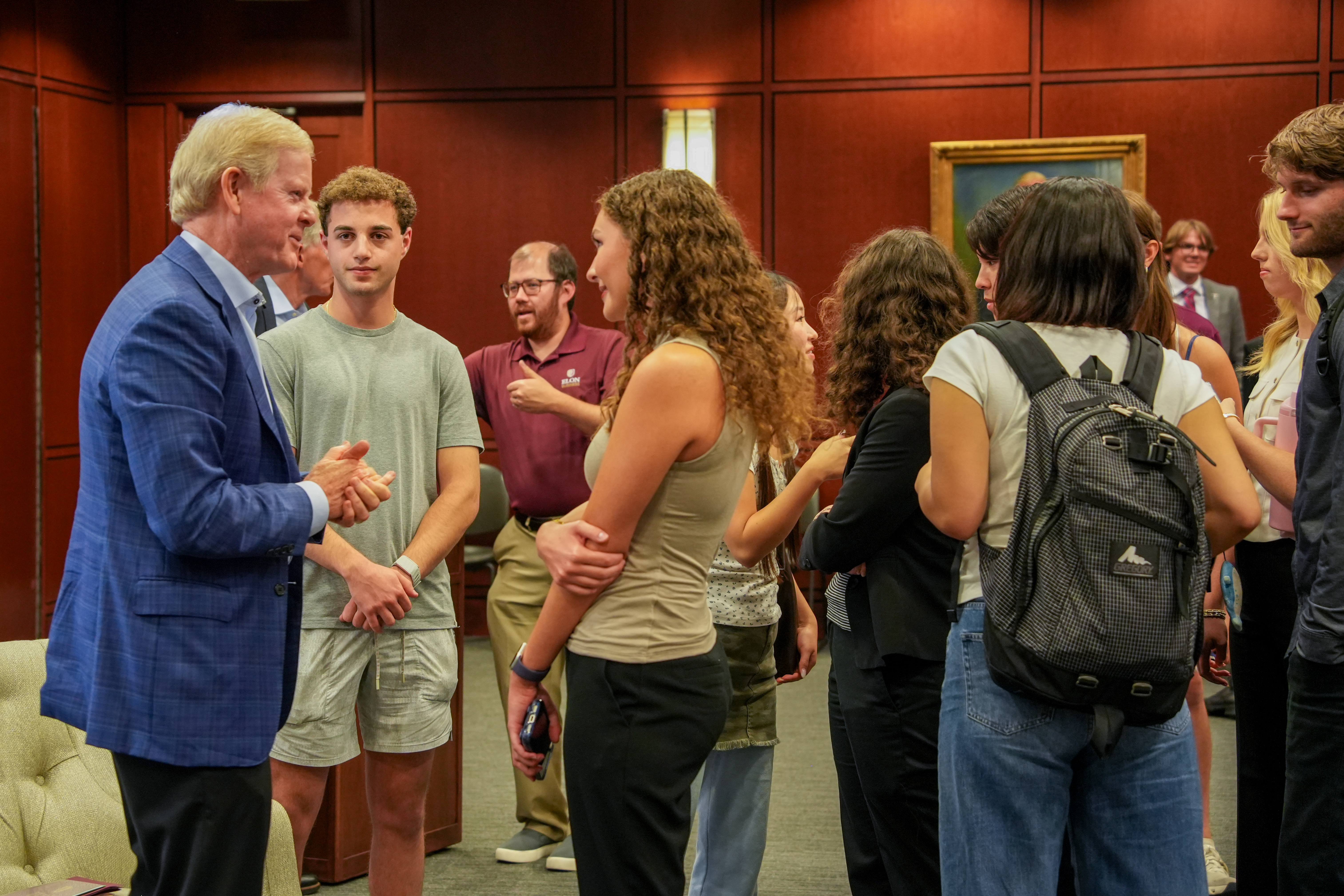 David Taylor talks with a group of students gathered around him after the event.