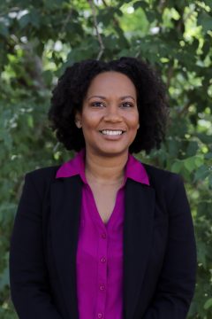 Headshot of Janeria Easley with a green background