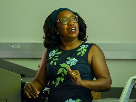 Ghislaine Lewis looks up at a presentation screen.