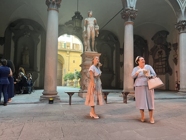 Two women perform an opera scene in a historic courtyard in Florence, Italy.