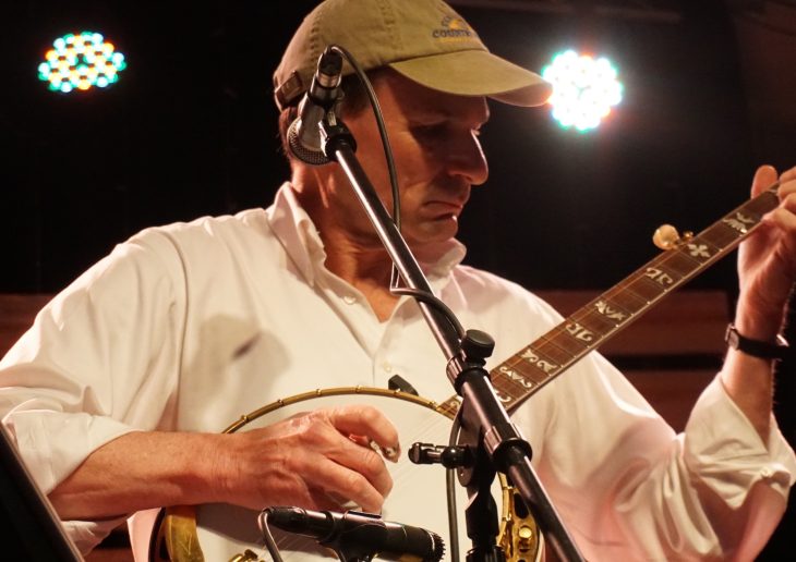 Close up of a man playing a banjo
