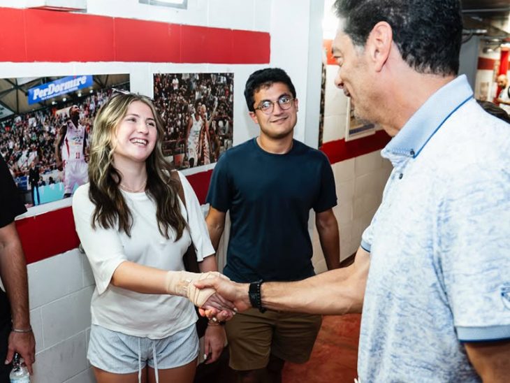 Elon student greeting Pistoia Basket President Joseph Mark David