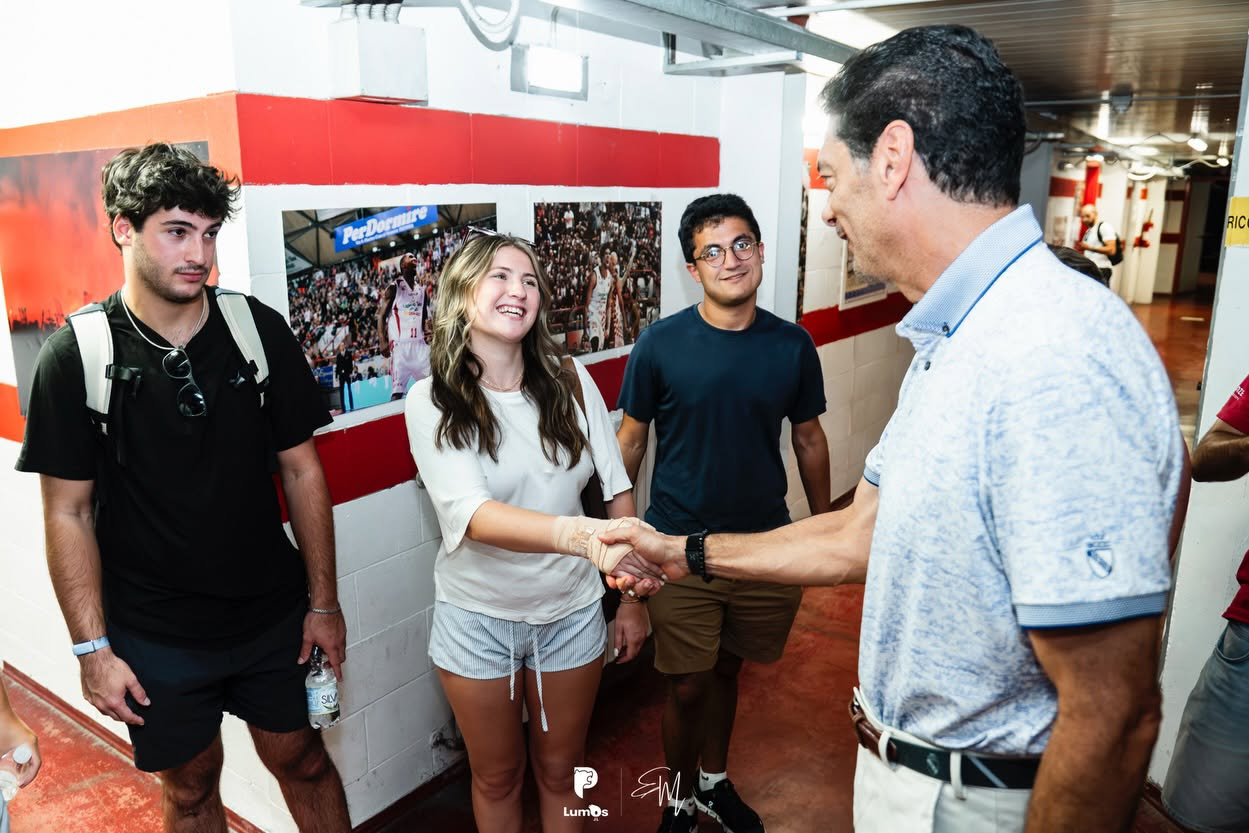 Elon student greeting Pistoia Basket President Joseph Mark David