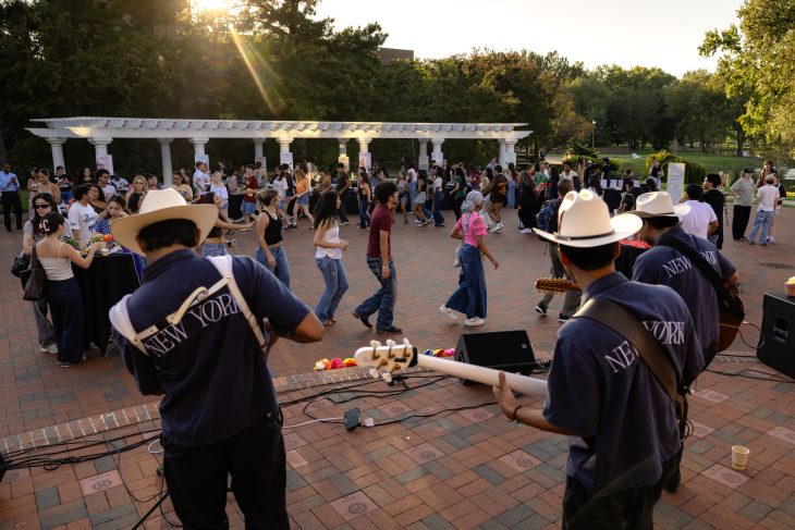 Students dance on Medallion Plaza as musicians perform during Elon’s Hispanic Heritage Month kickoff celebration.