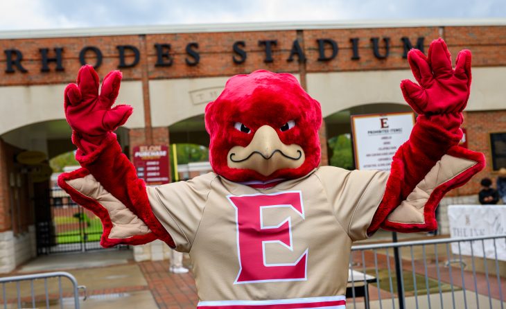 Elon University’s Phoenix mascot raises both hands outside Rhodes Stadium during Homecoming Weekend.