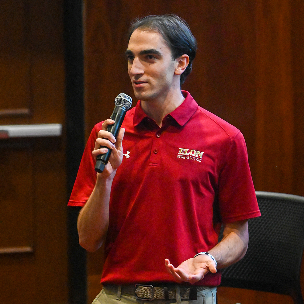 Elon's Anthony Bamford stands with a microphone