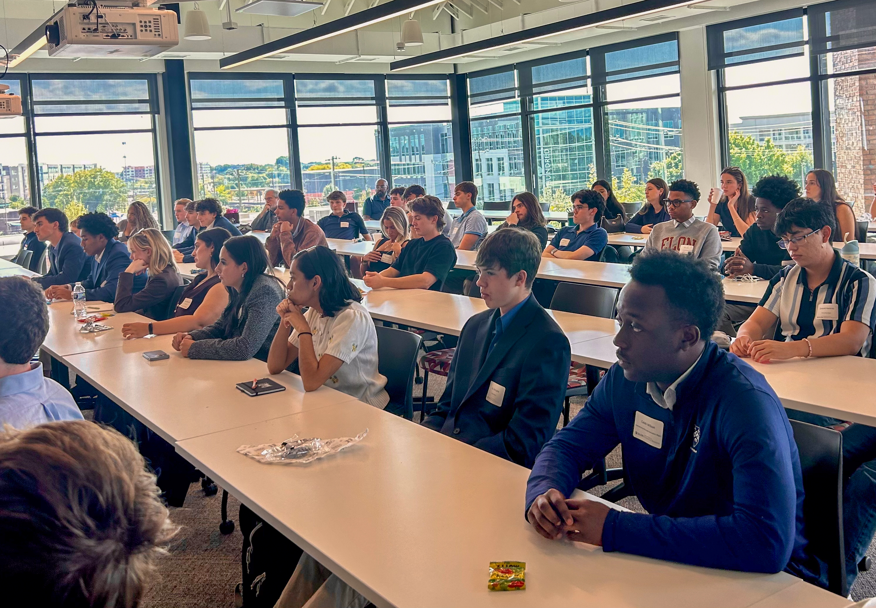 Elon students listen during a presentation as part of the Housing Equity Tour in Charlotte.