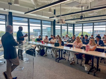 Students listen as a speaker addresses the group during the Housing Equity Tour in Charlotte.