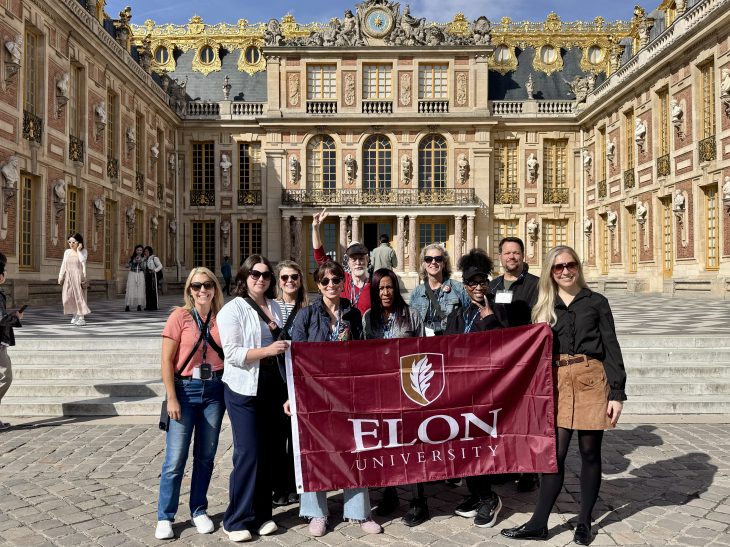 Elon University alumni, family members and friends in front of the Palace of Versailles in Oct. 2026.