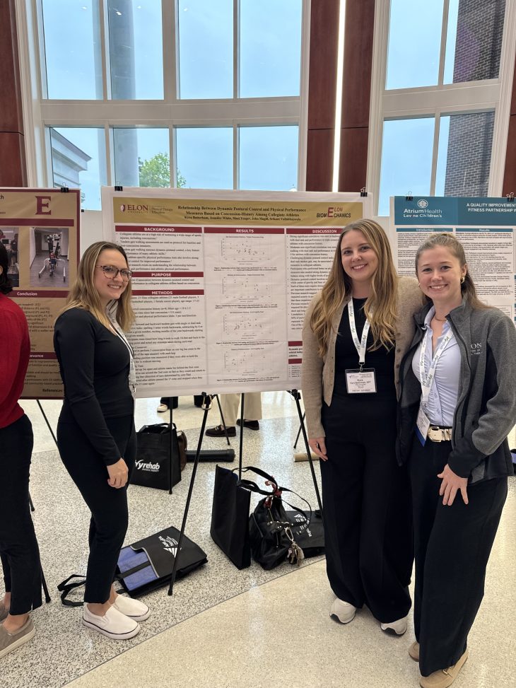 presenters standing in front of their poster