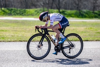 A person rides a bike in cycling gear