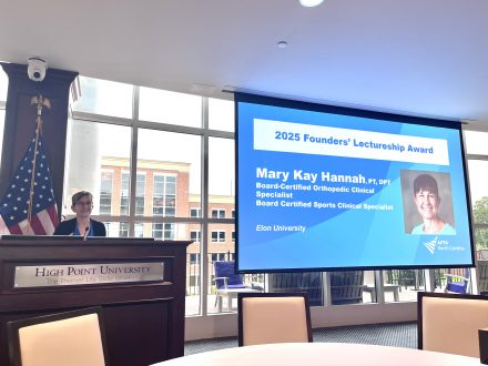 Person standing on podium to give her award talk