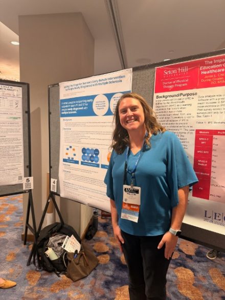 Person presenting their poster at a conference