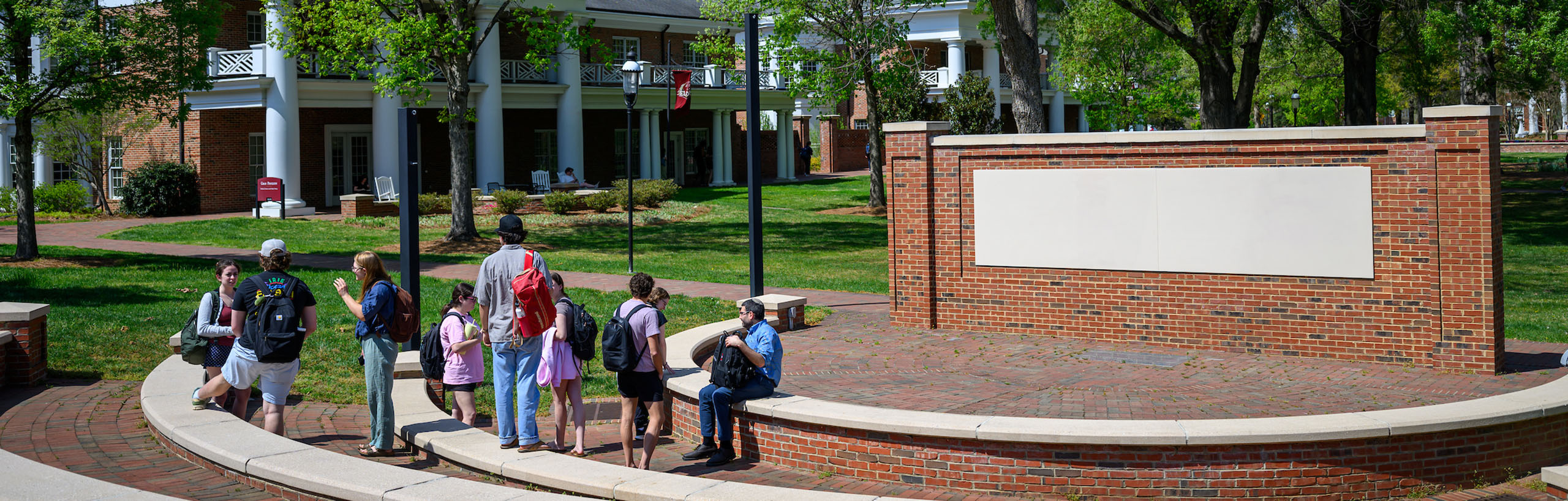 Photos of students and a professor gathered in the outdoor classroom space of Elon University's Academic Village in Spring 2026.
