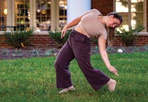 Student dancing in the Global Neighborhood grass
