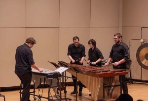 Members of the Percussion Ensemble playing a xylophone