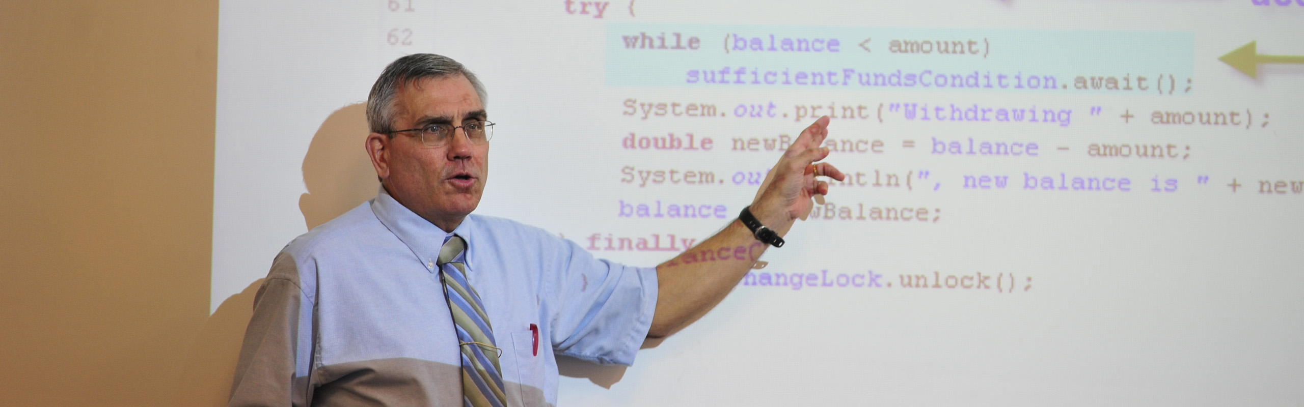 Photo of Dave Powell, Professor of Computing Sciences and Business Administration, teaching.