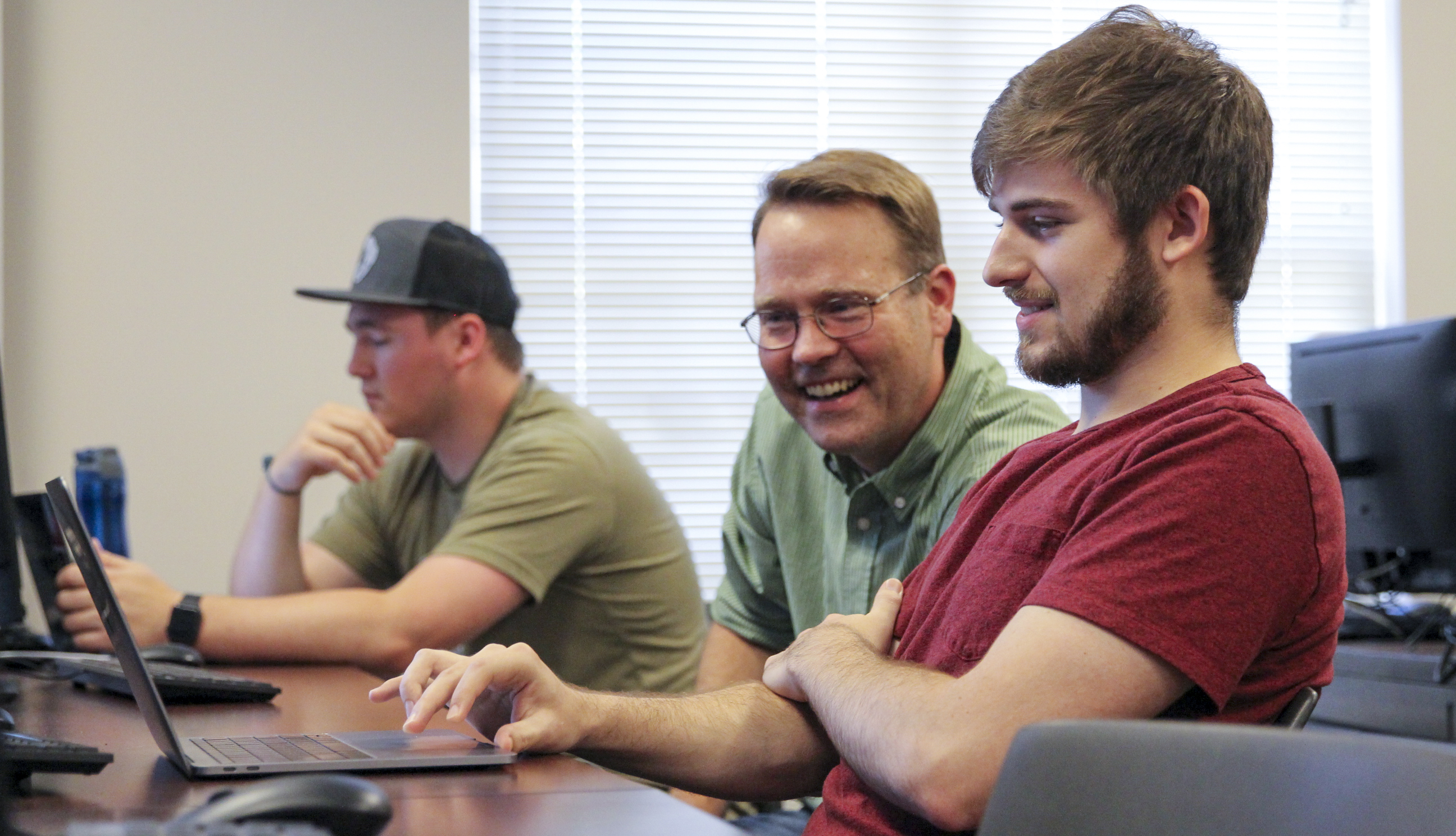 Associate Professor Scott Spurlock consults with students in the Computer Vision course.