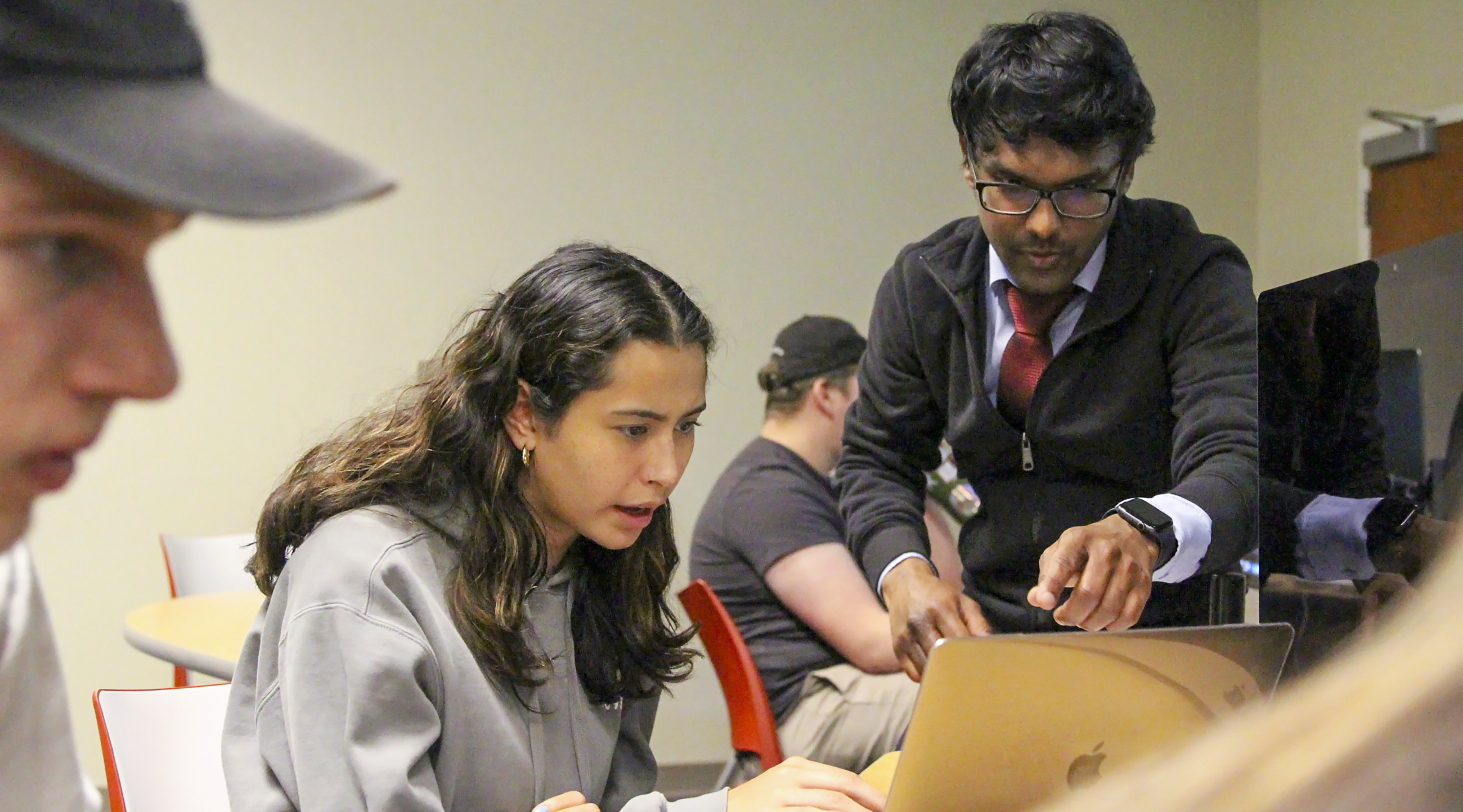 Assistant Professor Pratheep Paranthaman assists a student with game design.