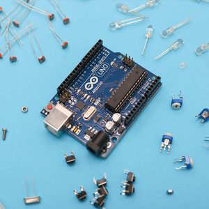 An arduino surrounded by electronic parts