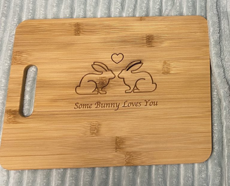 laser engraved cutting board that says Some Bunny Loves You